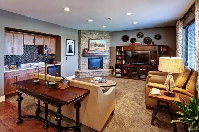A living room with a fireplace and a television  at The Piper, Kansas City, KS.